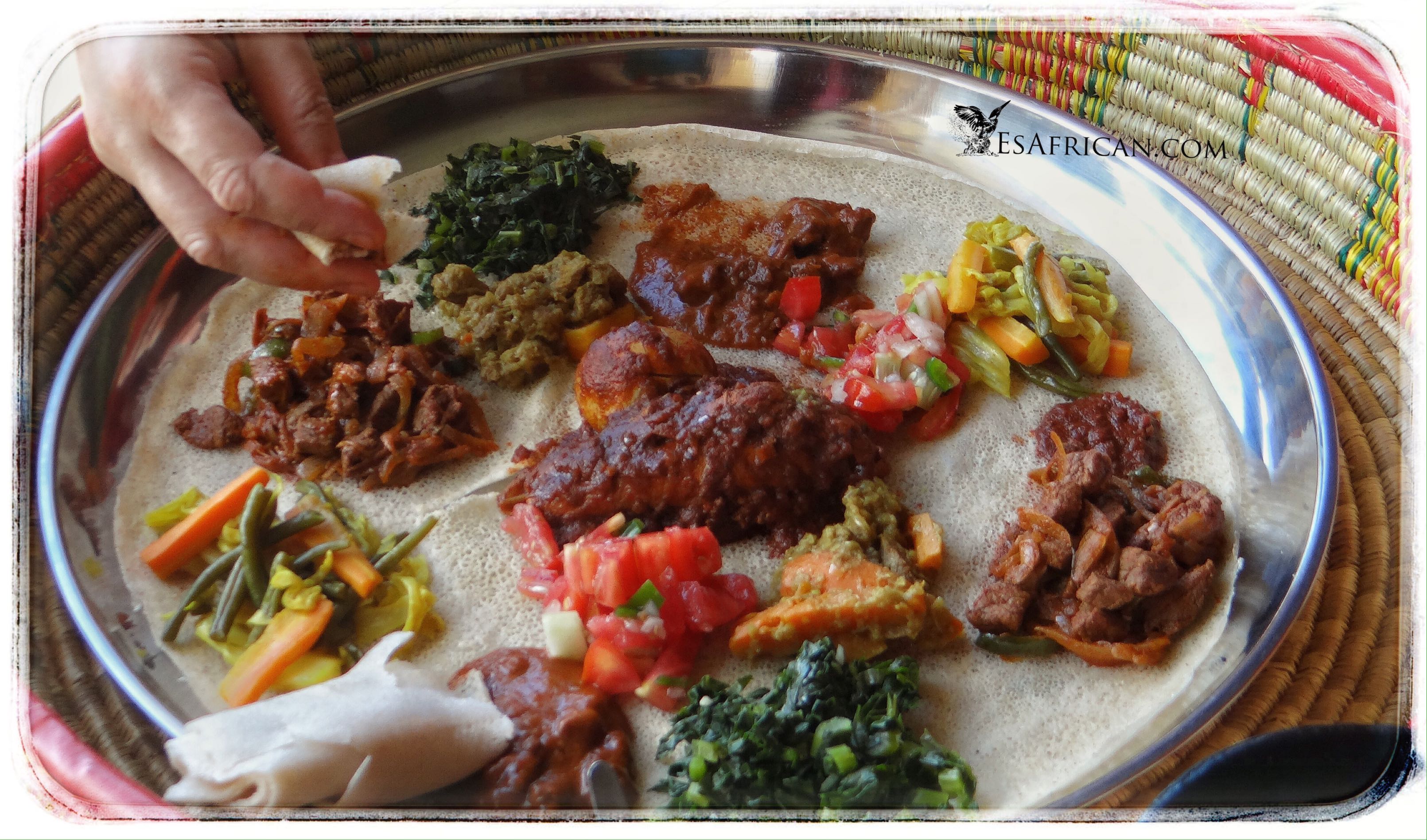 Delicious Ethiopian food is place on the injera within the moseb basket